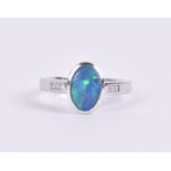 An 18ct white gold, diamond, and opal ring set with an oval opal (likely a doublet), collar set, the