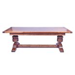 A large 18th century style oak refectory table the plank top supported on very large turned and