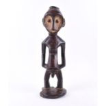 An 'Zande Ancestor' African carved tribal hardwood figure mid 20th century, designed as a man,