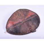 An early 20th century African leather shield of oval form with painted decoration, 79 cm x 58 cm.