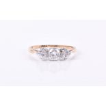 A three-stone diamond ring the central round brilliant-cut weighing approximately 0.37 carats,