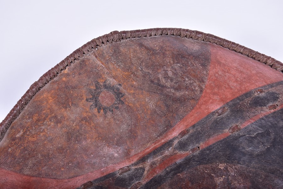 An early 20th century African leather shield of oval form with painted decoration, 79 cm x 58 cm. - Image 4 of 8