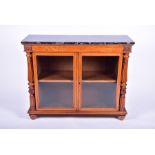 A George IV satinwood marble topped glazed low bookcase the black marble top over a pair of glazed