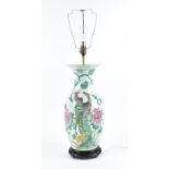 A late Qing dynasty famille rose porcelain converted table lamp of baluster form, the body painted