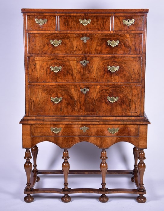 An 18th century walnut chest on stand the top with three short and three long graduated drawers, all