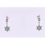 A pair of diamond and emerald earrings each drop-set with two round brilliant-cut diamonds,