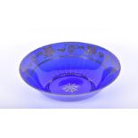 A Bristol blue glass bowl with gilt vine and grape decoration, 6 cm high x 21 cm diameter.