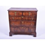 A George III mahogany chest with two short over three graduated drawers, brass drop handles on
