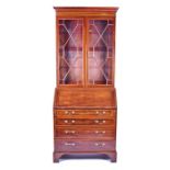 An Edwardian mahogany and inlaid bureau bookcase with twin astral-glazed doors, the flap opening