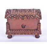 An early English carved oak dome-top table casket with stylised leaf decoration, on four feet, 20 cm