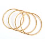 A group of four high carat gold Indian bangles unmarked, internal diameter 7.5 cm. (4)CONDITION