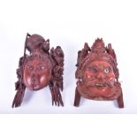 A pair of 20th century Chinese carved hardwood masks the largest mask 29 cm long, together with