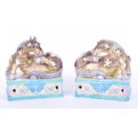 A pair of early 20th century Chinese ceramic recumbent horses each in polychrome enamels on