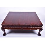 A very large 20th century hardwood coffee table the plain top with gadrooned rim and supported on
