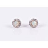 A pair of 18ct yellow gold, diamond, and opal cluster earrings of circular form, each centred with a