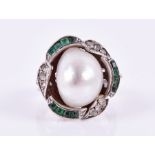 John Donald, London. A 1970s 18ct white gold, diamond, emerald, and pearl ring set with a Baroque