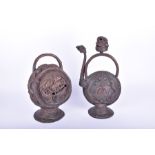 Two Tibetan copper incense burners each set with turquoise cabochons and mounted on pedestal bases