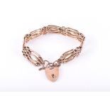 A 9ct rose gold gate-link bracelet textured and polished links, with heart-shaped padlock clasp.