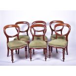 A set of six late Victorian balloon back dining chairs with overstuffed green-upholstered seats,