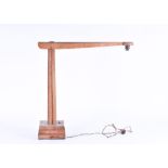 An early 20th century oak architect's/draughtsman's desk lamp on raised square platform base with