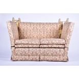 An early 20th century two seater knole sofa with drop ends, upholstered with a bird and foliage