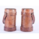 A pair of early 20th century leather cartridge cases  each bearing the military broad arrow and