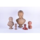 A group of 19th century terracotta and plaster busts each depicting young boys in classical poses,