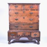 A George II oak and mahogany veneered chest on stand with moulded cornice, comprising eight