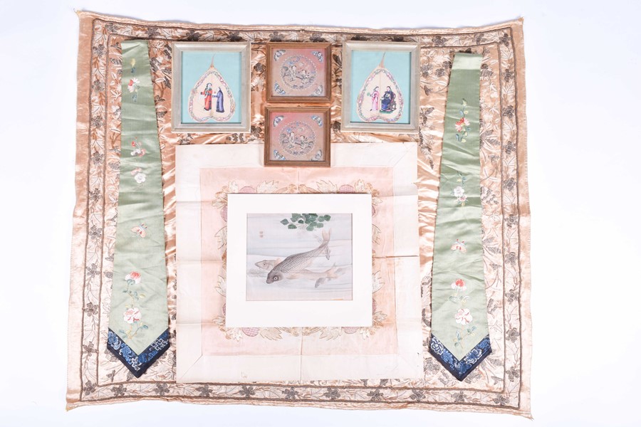 A pair of Chinese framed embroidered silk squares each depicting children in an outdoor setting