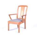 An Arts & Crafts style oak armchair with upholstered seat by Stanley Webb Davies with angular shaped