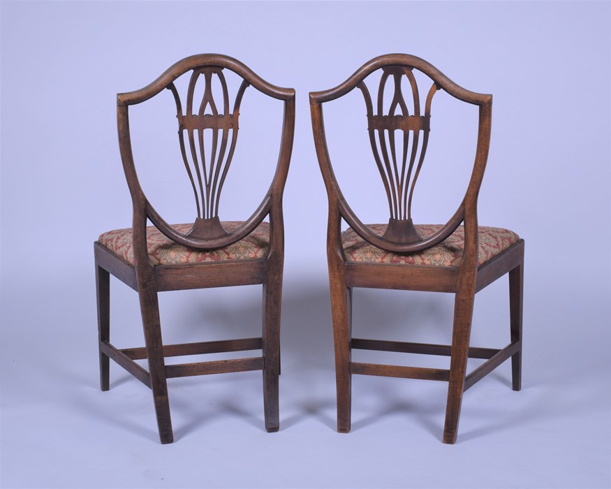 A pair of late Georgian mahogany shield back dining chairs after a design by George Hepplewhite with - Image 2 of 5