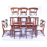 A large Victorian extending dining table with two sets of six conforming chairs the mahogany table