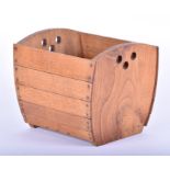 A mid 20th century oak magazine basket or coal scuttle of barrel form, in the Arts & Crafts style,