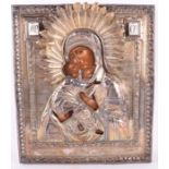 An early 19th century Russian icon of Vladimirskaya with silver gilt riza the Mother of God is