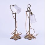 A pair of Edwardian brass table lamps  on thin fluted columns with adjustable arms, on stepped