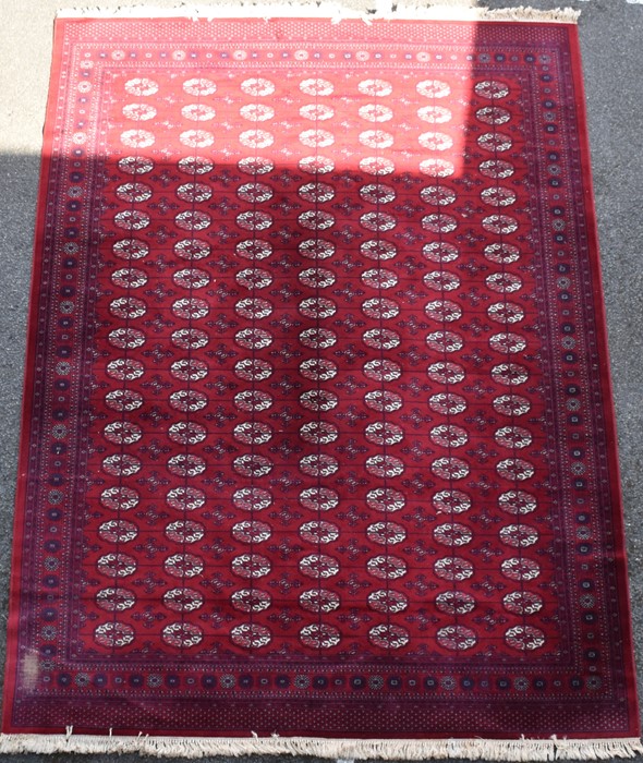 A large Persian Bokhara style rug decorated with ornate border, geometric motifs and medallions on a - Image 3 of 5