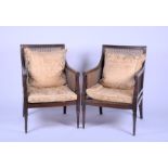 A pair of Regency style library chairs with cane upholstery the frames with fluted and foliate