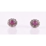 A pair of 18ct white gold, diamond, and star ruby cluster earrings of oval form, approximately 1