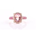 An 18ct rose gold, diamond, pink sapphire, and morganite cluster ring set with a mixed oval-cut