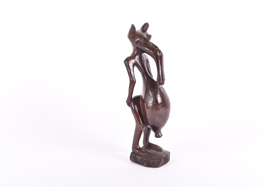 A carved African fertility sculpture modelled as an animalistic figure, 31.5 cm high, together - Image 17 of 20