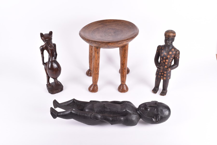 A carved African fertility sculpture modelled as an animalistic figure, 31.5 cm high, together