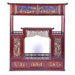 A 20th century Chinese carved hardwood display cabinet the top fitted with two deep drawers,