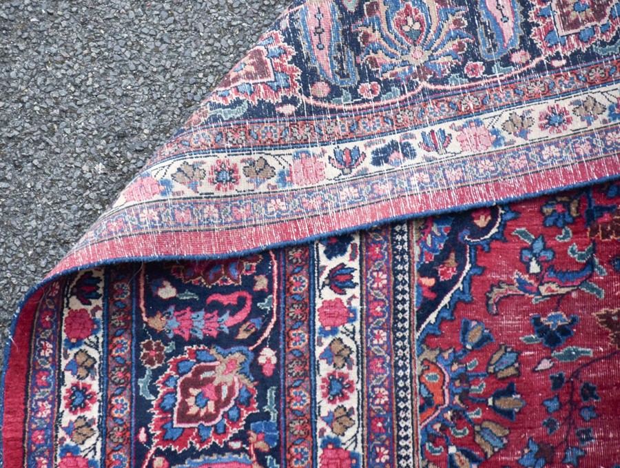 A large Persian Isfahan carpet designed with a red ground central medallion surrounded with shah - Image 9 of 9