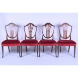 A set of four mahogany Hepplewhite style shield back dining chairs with overstuffed seats, on