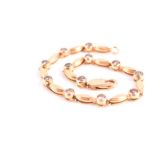 An 18ct yellow gold and cognac diamond bracelet the twelve collet-set round brilliant-cut diamonds