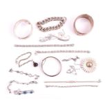 A group of silver and white metal jewellery including three hinged bangles, a silver and lapis