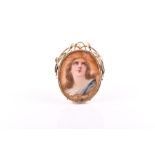 An unusual Continental yellow metal portrait pendant in the Art Nouveau taste, set with an antique