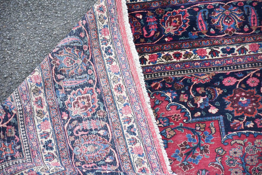 A large Persian Isfahan carpet designed with a red ground central medallion surrounded with shah - Image 8 of 9