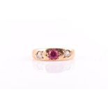 A late 19th / early 20th century 18ct yellow gold diamond and ruby gypsy ring inset with a round-cut