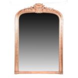 A 19th century gilt gesso and wood overmantle mirror designed with arched top, with a scroll and